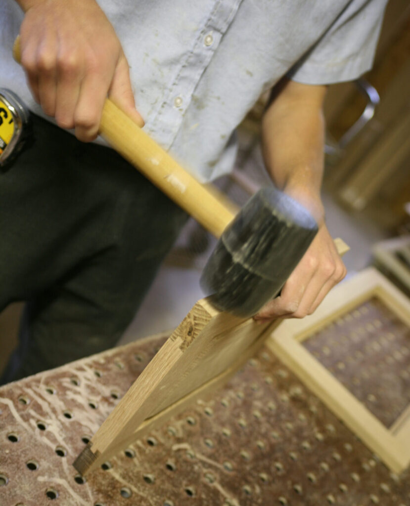 Amish Cabinetmaker Constructing Cabinet Door